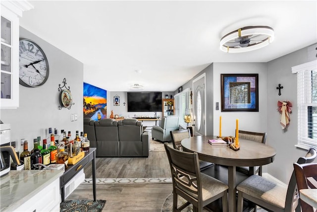 dining room with a ceiling fan and wood finished floors