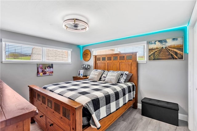 bedroom featuring light wood-style flooring and baseboards