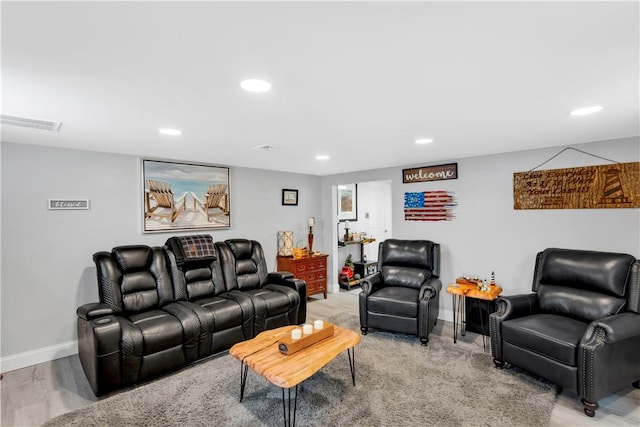 living area with baseboards, recessed lighting, visible vents, and light wood-type flooring