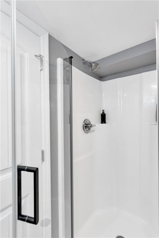 full bath with a shower stall