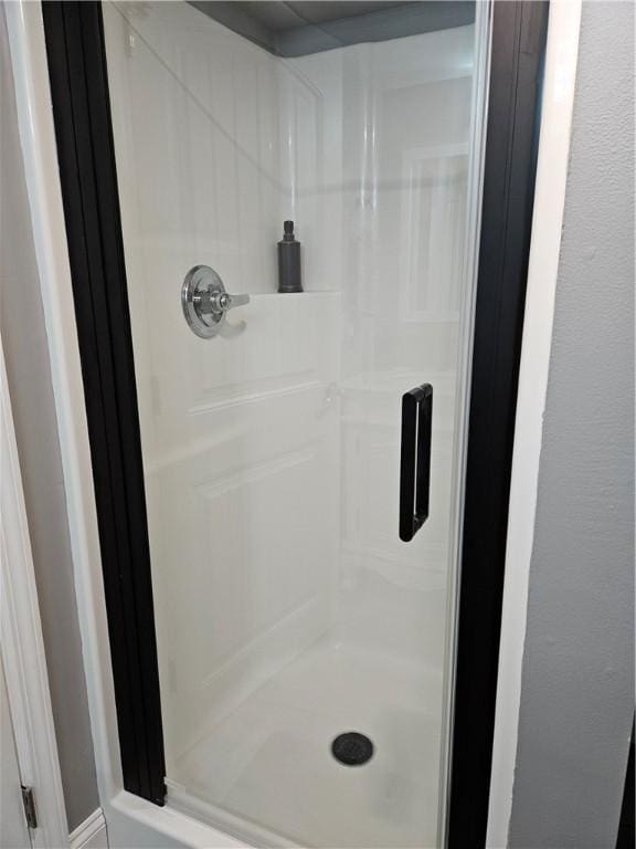 full bath featuring a shower stall