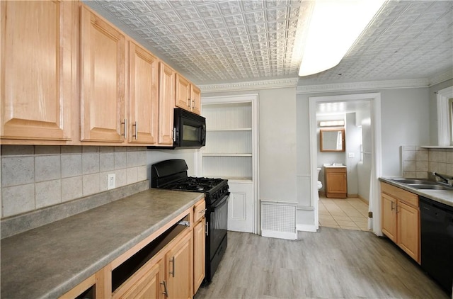 2331 Jane St, South Side, PA 15203 - kitchen with black appliances, a sink, an ornate ceiling, light wood-type flooring, and tasteful backsplash