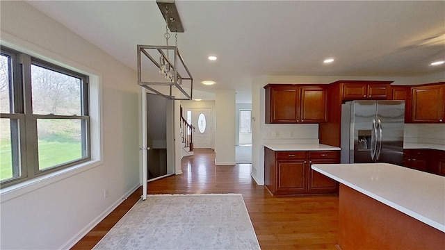kitchen featuring stainless steel fridge, light countertops, and a wealth of natural light