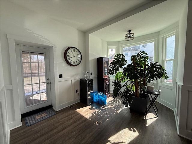 6755 Mcpherson Blvd, Point Breeze, PA 15208 - doorway featuring wainscoting, a decorative wall, dark wood-style floors, and visible vents