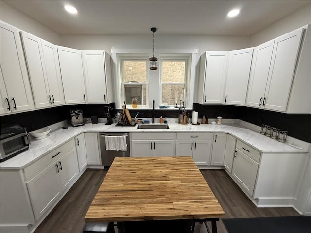 6755 Mcpherson Blvd, Point Breeze, PA 15208 - kitchen with light stone counters, dishwasher, a sink, dark wood-type flooring, and white cabinetry