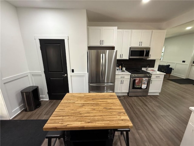 6755 Mcpherson Blvd, Point Breeze, PA 15208 - kitchen with tasteful backsplash, light countertops, appliances with stainless steel finishes, white cabinetry, and dark wood-style flooring