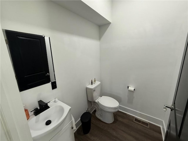 6755 Mcpherson Blvd, Point Breeze, PA 15208 - half bathroom with wood finished floors, visible vents, toilet, and baseboards