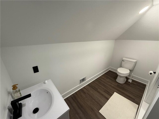6755 Mcpherson Blvd, Point Breeze, PA 15208 - half bath featuring vaulted ceiling, wood finished floors, baseboards, toilet, and visible vents