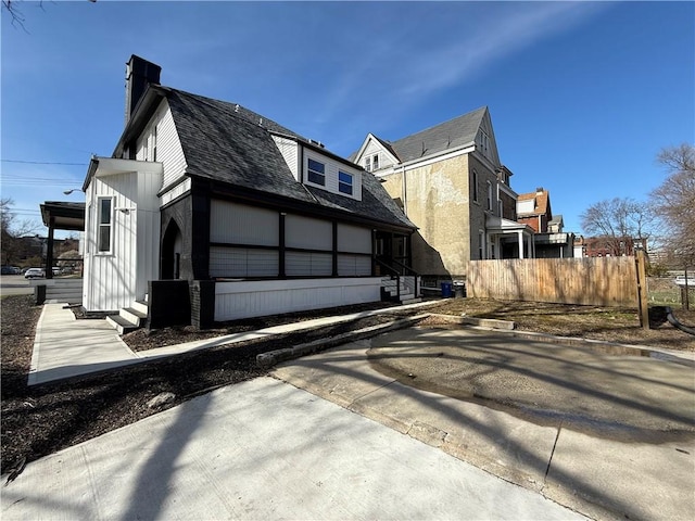 6755 Mcpherson Blvd, Point Breeze, PA 15208 - view of home's exterior featuring a chimney, fence, a shingled roof, and entry steps