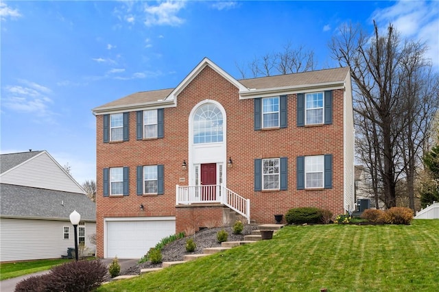 1743 Holmes Dr, Franklin Park, PA 15143 - colonial house with a front lawn, brick siding, driveway, and a garage