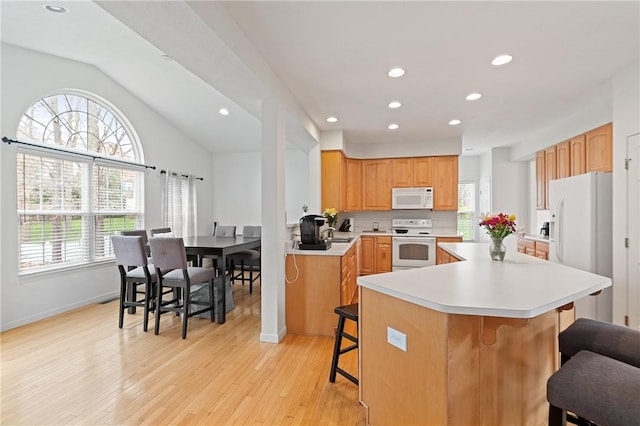 1743 Holmes Dr, Franklin Park, PA 15143 - kitchen with recessed lighting, light wood finished floors, a breakfast bar area, and white appliances