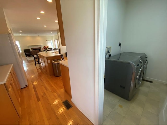 1743 Holmes Dr, Franklin Park, PA 15143 - washroom featuring washer and clothes dryer, visible vents, a fireplace, laundry area, and recessed lighting