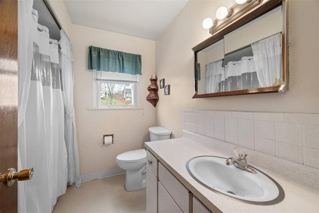 bathroom featuring baseboards, toilet, vanity, and a shower with curtain