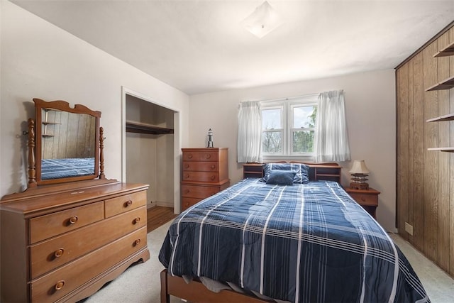 bedroom with a closet and light colored carpet