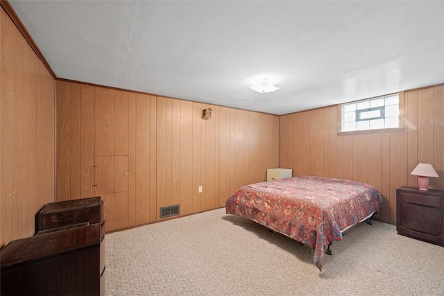 bedroom featuring carpet, visible vents, and wood walls