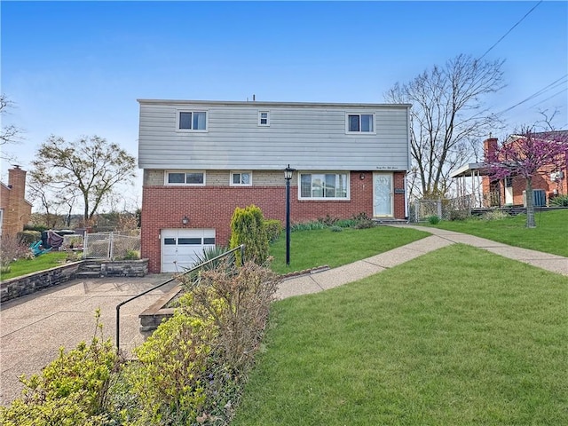 3157 Bel Air Dr, Whitehall, PA 15227 - view of front facade featuring driveway, fence, brick siding, an attached garage, and a front yard