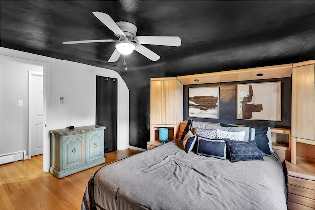 3530 Ridgeway Dr, Bethel Park, PA 15102 - bedroom with a baseboard heating unit, light wood-type flooring, a ceiling fan, and baseboards