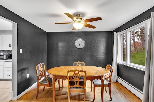 3530 Ridgeway Dr, Bethel Park, PA 15102 - dining room with baseboard heating, ceiling fan, baseboards, and light wood-style flooring