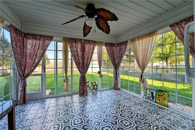 unfurnished sunroom with a ceiling fan
