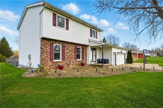 view of front of property featuring brick siding, an attached garage, a front yard, and concrete driveway
