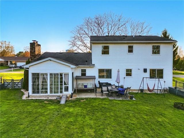 rear view of house featuring a fenced backyard, a yard, and a patio