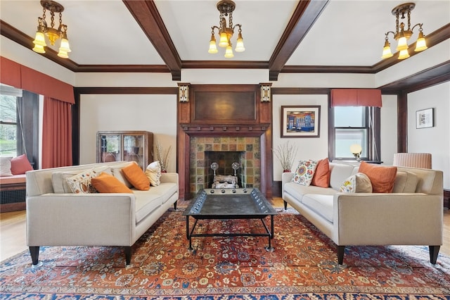 5818 Aylesboro Ave, Squirrel Hill, PA 15217 - living room with a chandelier, beamed ceiling, crown molding, a tile fireplace, and wood finished floors