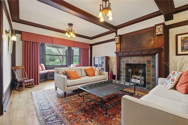 5818 Aylesboro Ave, Squirrel Hill, PA 15217 - living room featuring crown molding, light wood finished floors, a tiled fireplace, and beam ceiling