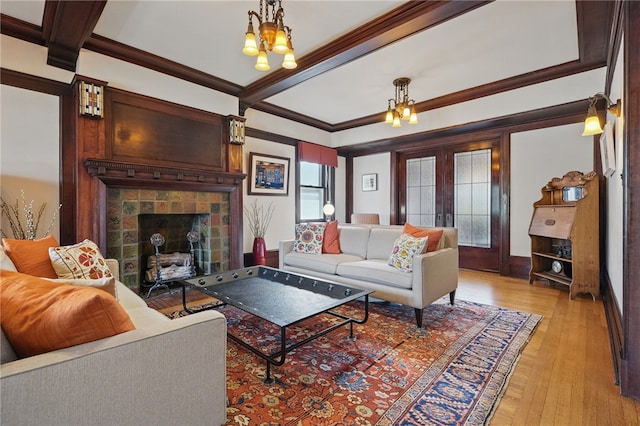 5818 Aylesboro Ave, Squirrel Hill, PA 15217 - living room with light wood-style flooring, crown molding, a fireplace, and a chandelier