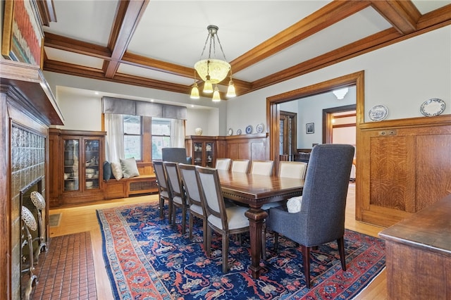 5818 Aylesboro Ave, Squirrel Hill, PA 15217 - dining room featuring beamed ceiling, coffered ceiling, wood finished floors, a chandelier, and ornamental molding