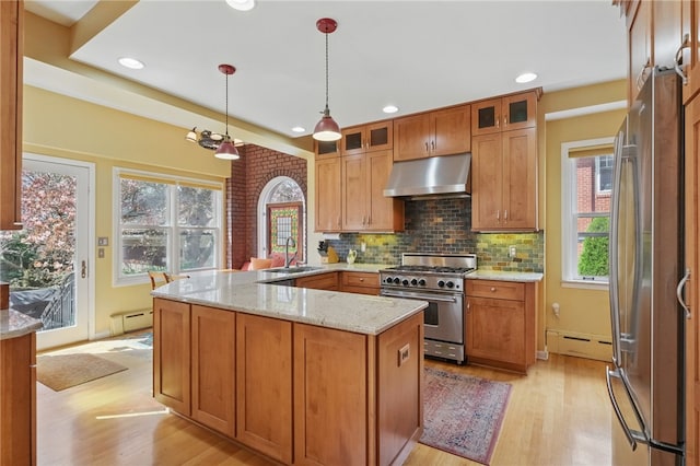 5818 Aylesboro Ave, Squirrel Hill, PA 15217 - kitchen with under cabinet range hood, appliances with stainless steel finishes, a sink, light wood-style floors, and a baseboard heating unit