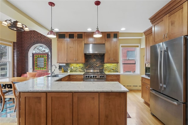 5818 Aylesboro Ave, Squirrel Hill, PA 15217 - kitchen featuring stainless steel appliances, under cabinet range hood, a sink, a baseboard heating unit, and a peninsula