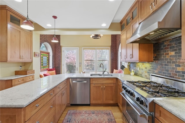 5818 Aylesboro Ave, Squirrel Hill, PA 15217 - kitchen featuring stainless steel appliances, under cabinet range hood, a sink, light wood-style flooring, and light stone counters