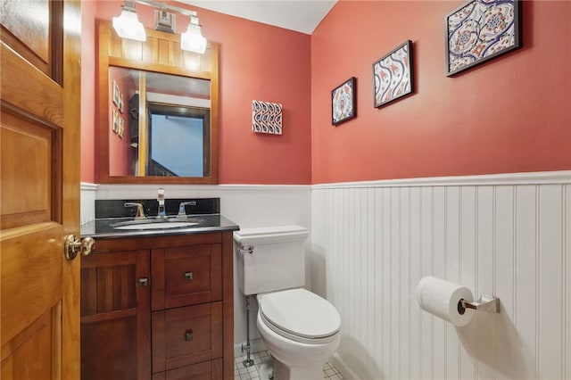 5818 Aylesboro Ave, Squirrel Hill, PA 15217 - half bathroom with a wainscoted wall, toilet, vanity, and tile patterned floors