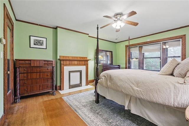 5818 Aylesboro Ave, Squirrel Hill, PA 15217 - bedroom with ornamental molding, wood finished floors, a brick fireplace, and baseboards