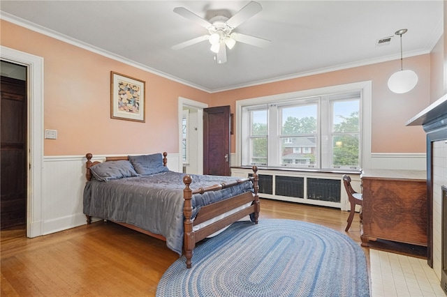 5818 Aylesboro Ave, Squirrel Hill, PA 15217 - bedroom with radiator, wood finished floors, ornamental molding, wainscoting, and ceiling fan