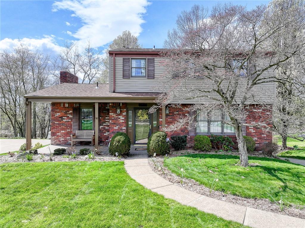 1619 Sharpshill Rd, Shaler, PA 15215 - traditional-style home with brick siding, a chimney, and a front yard