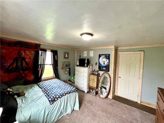 bedroom with carpet flooring and baseboards