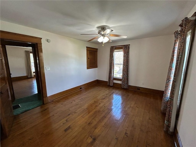 509 W Erie St, Linesville Boro, PA 16424 - spare room with baseboards, visible vents, dark wood-type flooring, and ceiling fan