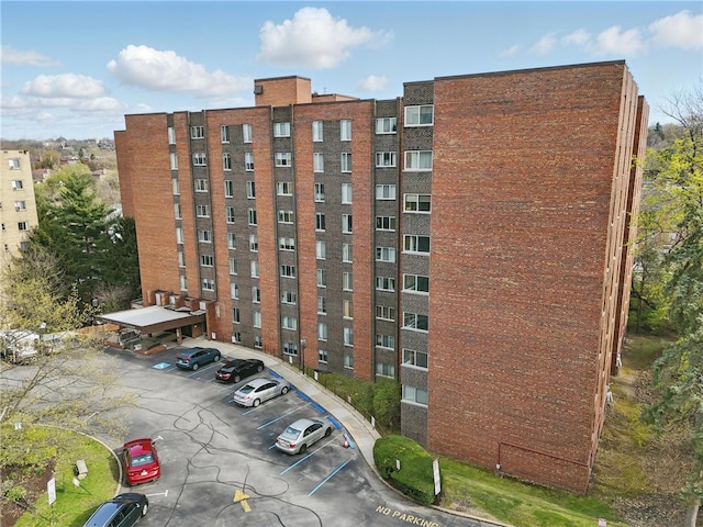 view of building exterior featuring uncovered parking