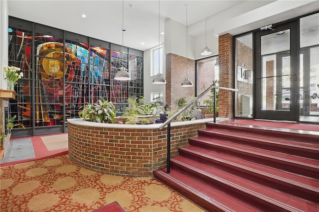interior space featuring a wealth of natural light and brick wall