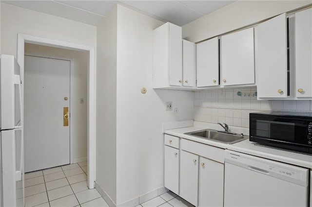 kitchen with light countertops, a sink, white appliances, decorative backsplash, and white cabinetry