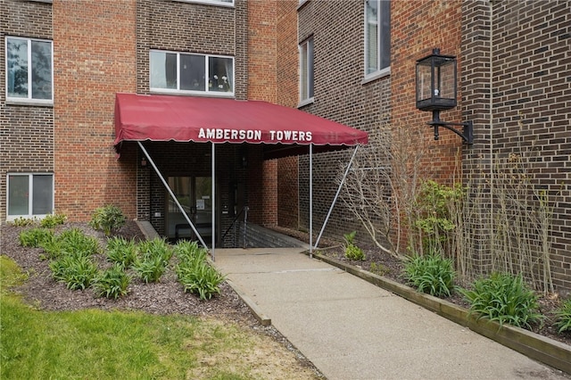 doorway to property featuring brick siding