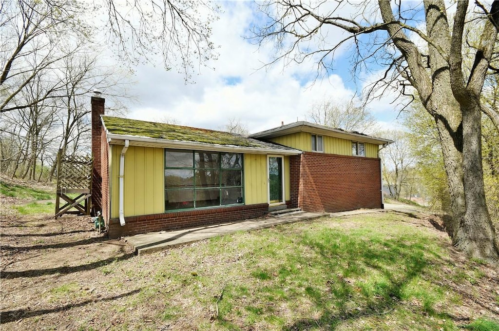 98 Reel Ave, Ross Twp, PA 15237 - rear view of property featuring brick siding and a chimney