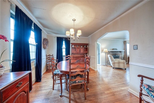 120 Arden Dr, Shaler, PA 15116 - dining room with arched walkways, crown molding, a chandelier, and light wood finished floors