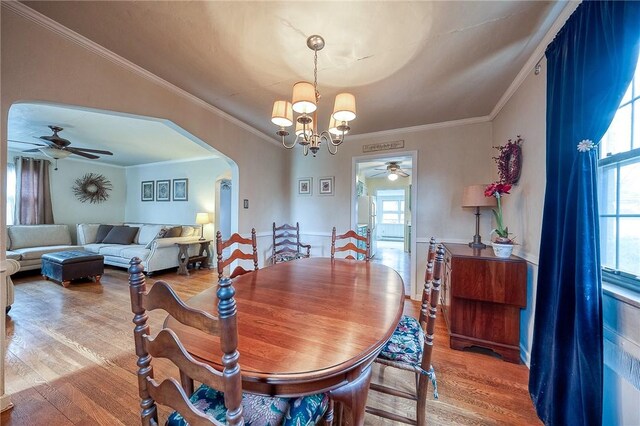 120 Arden Dr, Shaler, PA 15116 - dining space featuring ceiling fan with notable chandelier, wood finished floors, and arched walkways