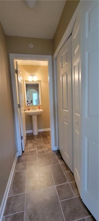hall featuring baseboards