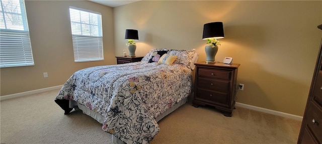 bedroom with light carpet and baseboards