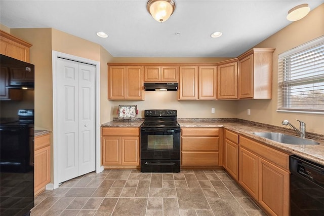 kitchen with black appliances, light brown cabinets, under cabinet range hood, and a sink