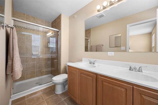 full bathroom featuring visible vents, a stall shower, and a sink