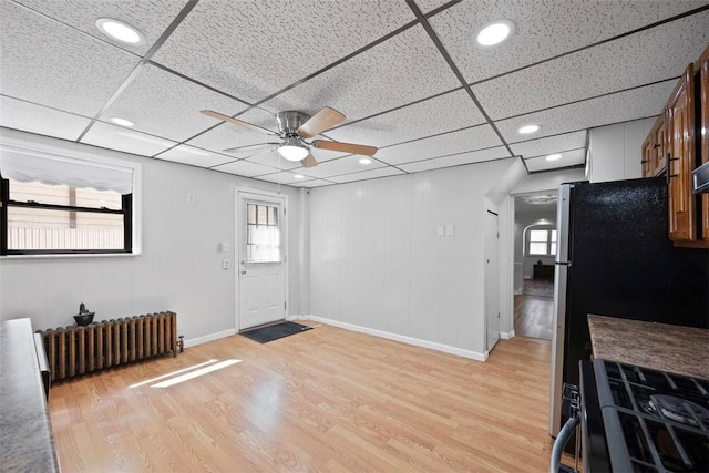 entryway with radiator heating unit, light wood-style flooring, a wealth of natural light, and ceiling fan